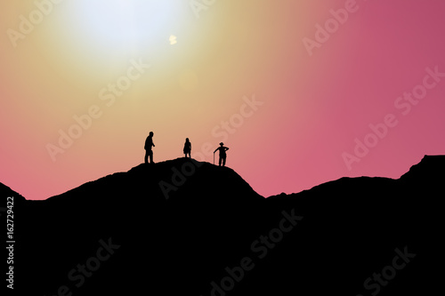 Silhouettes of people on mountains- Stock Image