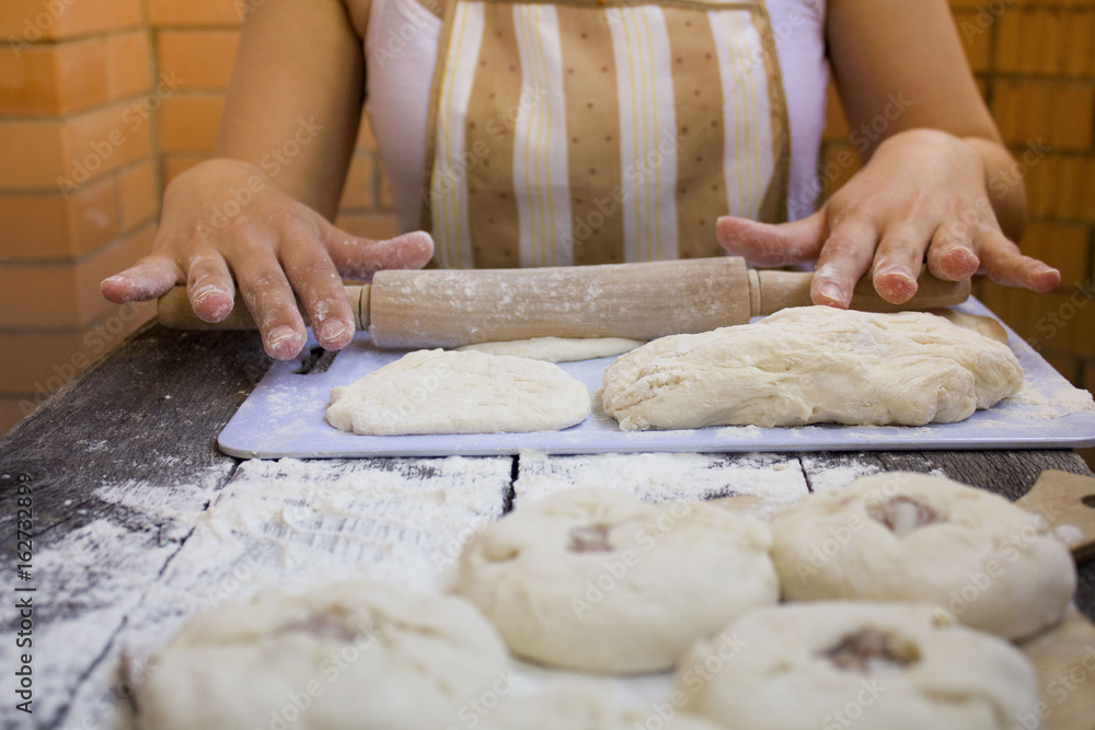 the girl prepares a pie with meat and onions the girl prepares a pie with meat and onions