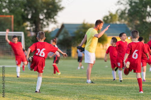 Kids soccer football - children players exercising before match on soccer field © Dusan Kostic