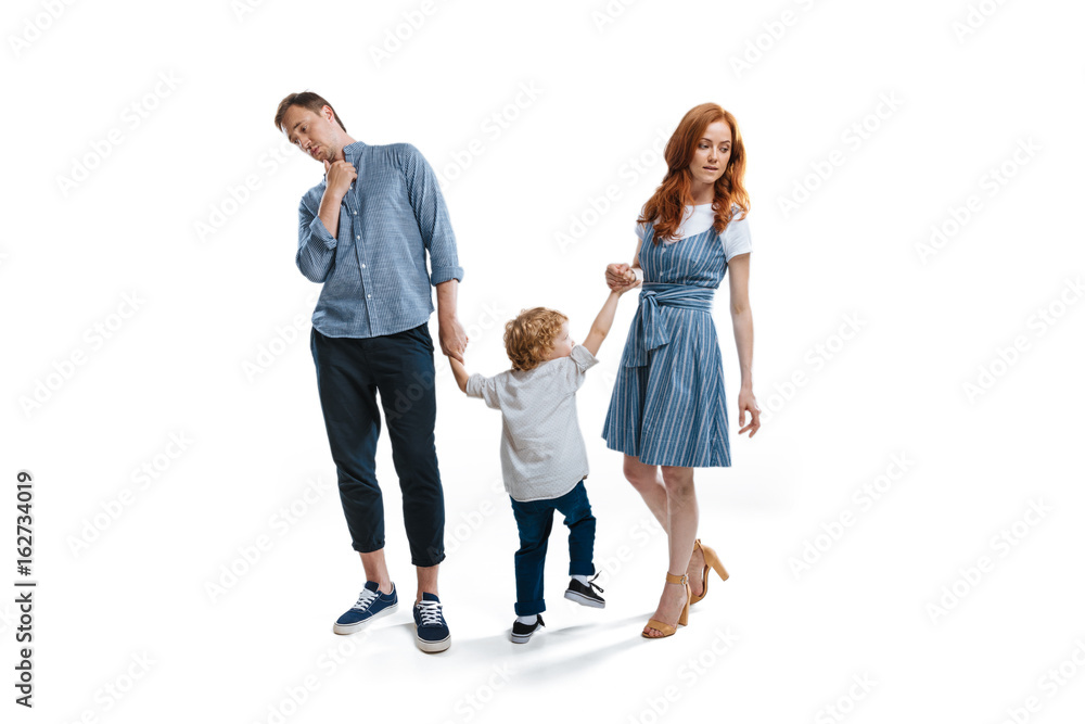 Happy family with one child holding hands and walking isolated on white Happy family with one child holding hands and walking isolated on white