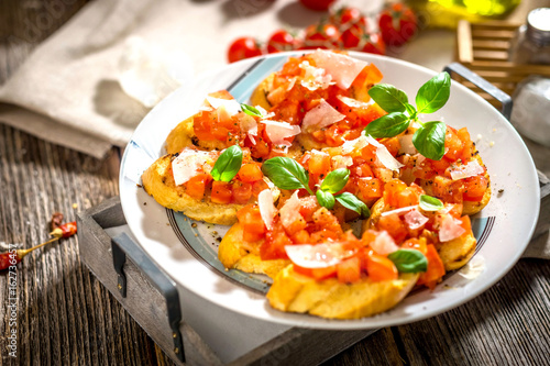 Tasty bruschetta with tomato,  basil, parmesan, olive oil ...