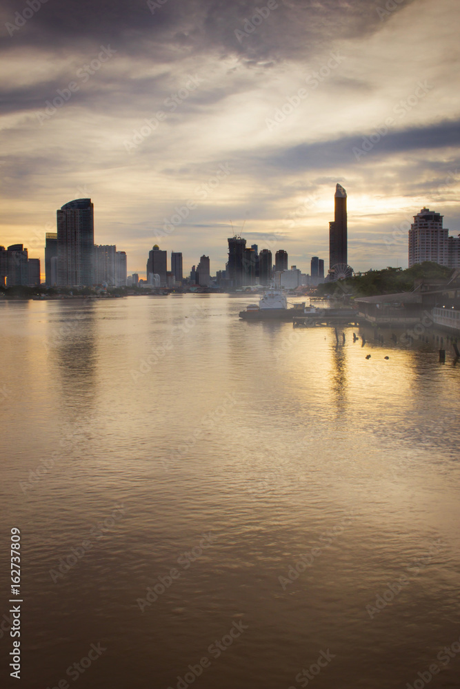 View of the Chao-Phraya-River at dawn with gray cloud cover. Bangkok, Thailand