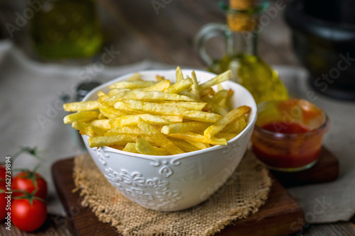 Homemade french fries on wooden background