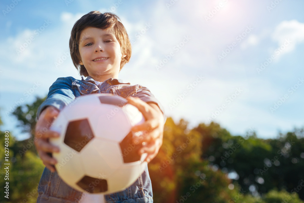 Charming vibrant kid inviting you for a game Charming vibrant kid inviting you for a game