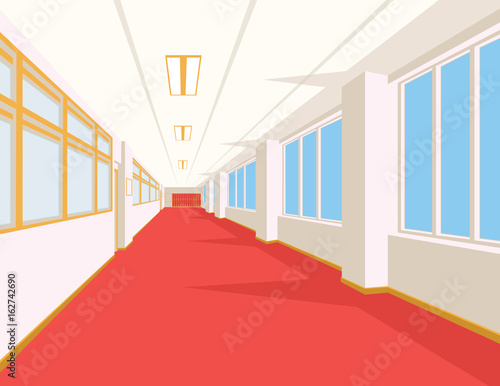 Interior of school hall with red floor, windows and columns.