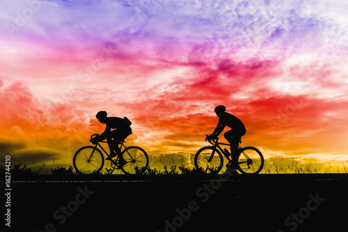 Silhouette of sportsmen riding a bicycle © palidachan