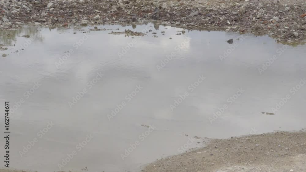Dirty ground road with puddles and reflections. Dirty ground road with puddles and reflections.