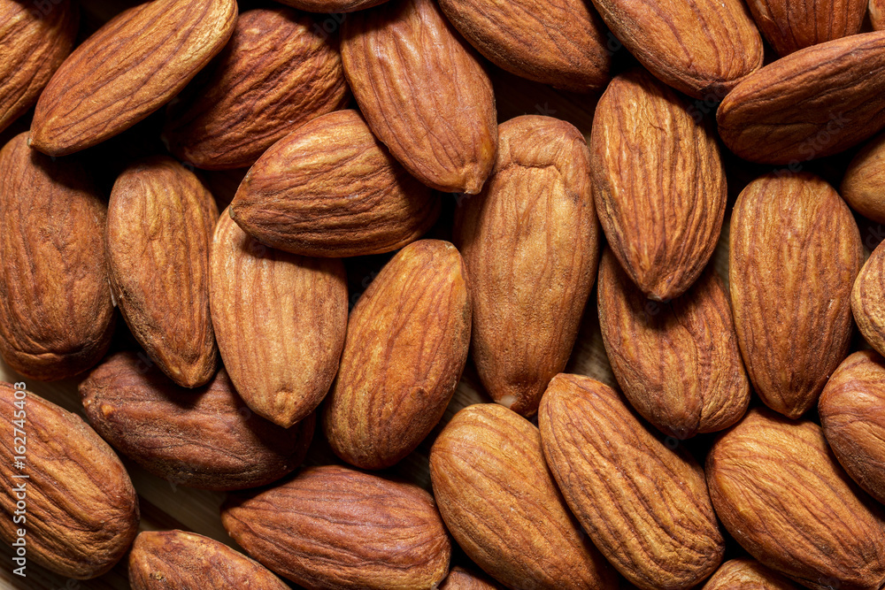 Fototapeta premium Dry brown apricot kernels full screen