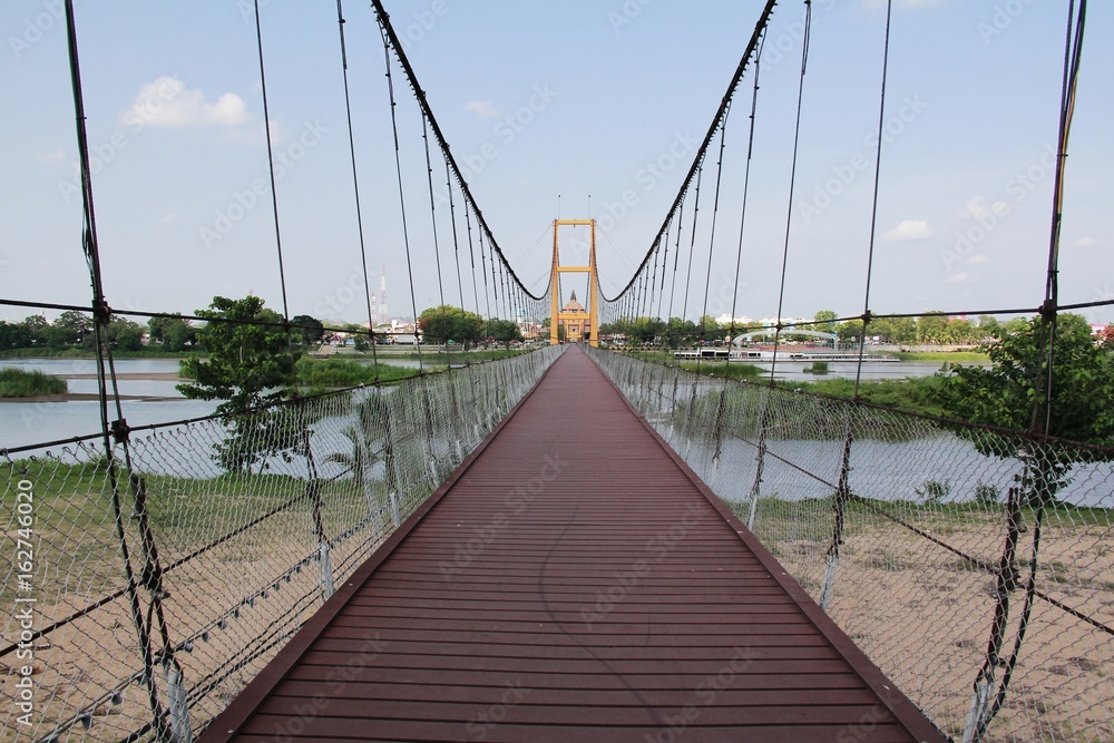 Yellow Suspension Bridge Architecture With doors blocking the passage that can pass through. Which is considered to be very popular.