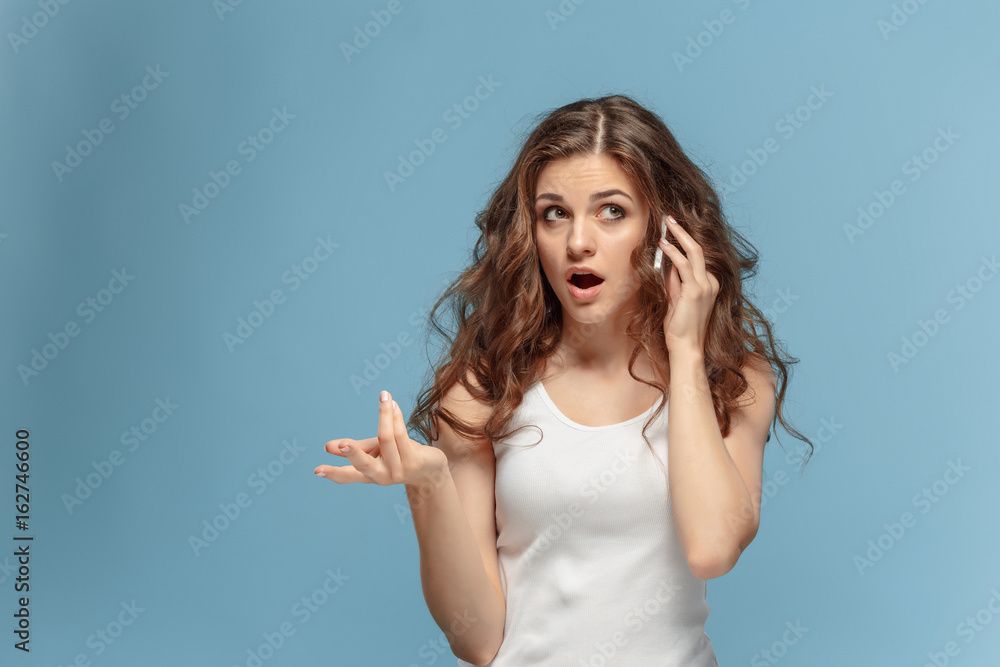 The portrait of disgusted woman with mobile phone The portrait of disgusted woman with mobile phone