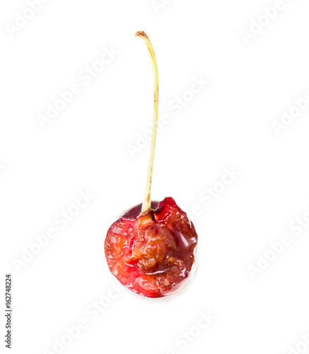 One bitten cherry on a white background photo