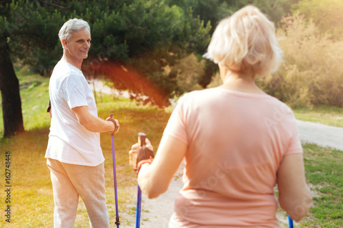 Positive elderly couple exercising together