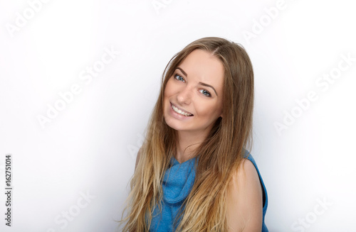 Headshot of young adorable blonde woman with cute smile wearing big black professional monitoring headphones against white studio background