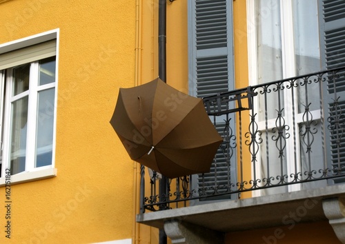 Fotobehang Umbrella put on drying on the balustrade