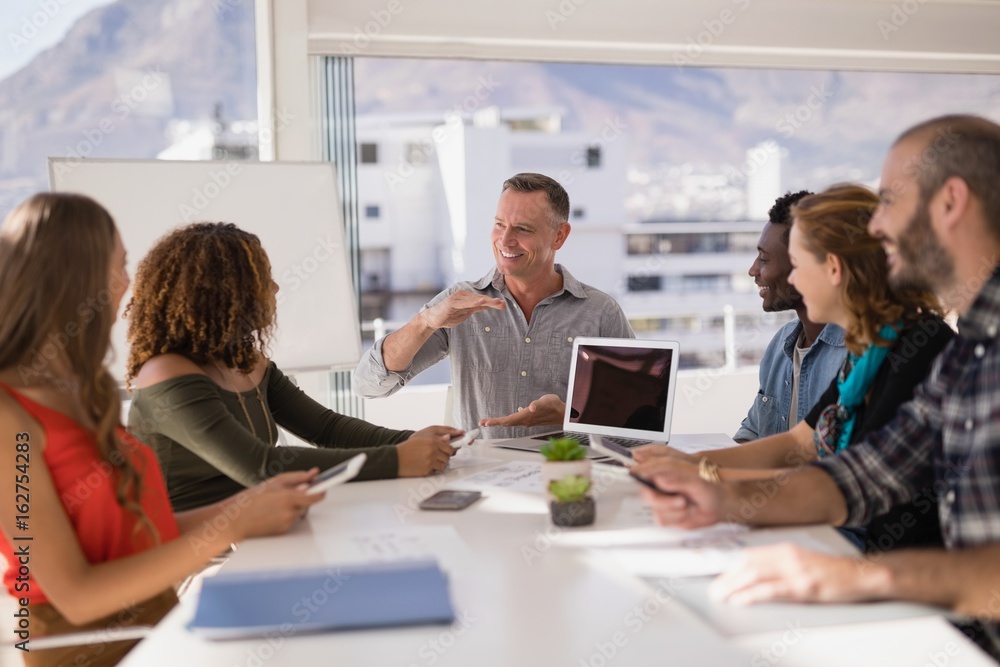 Executive having discussion in conference room Executive having discussion in conference room