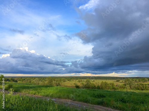 Cloudscape over river valley at sunset   