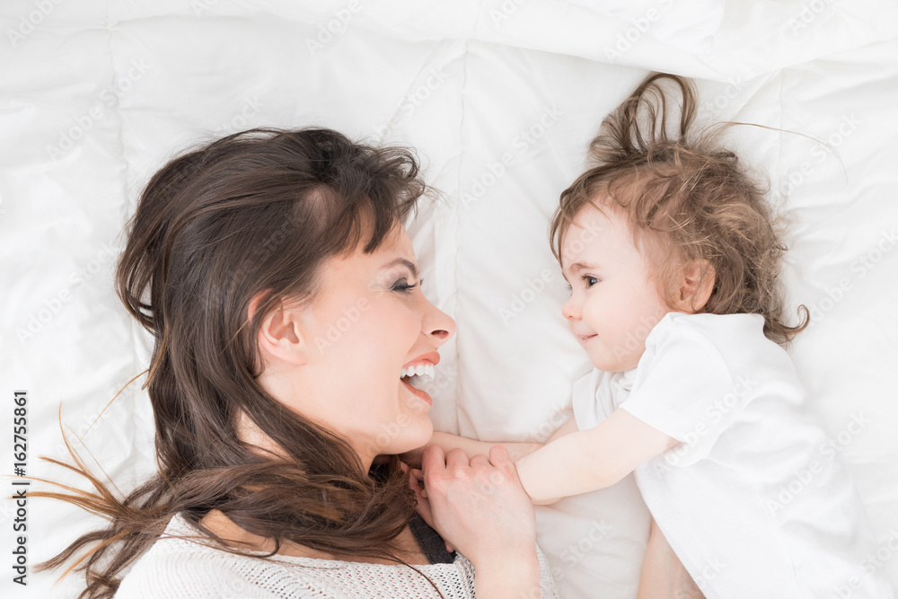 Smiling mother with baby girl. Daughter close to loving mom. Smiling mother with baby girl. Daughter close to loving mom.