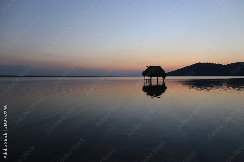 Overwater Hut and Sunset - Lake Peten Itza in Guatemala