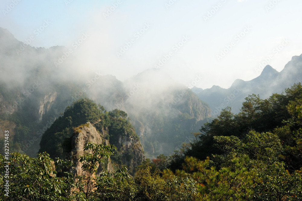 A low hanging cloud against blue sky in the early morning at Fangdong Scenic Area on Yandangshan mountains located in Zhejiang province China.