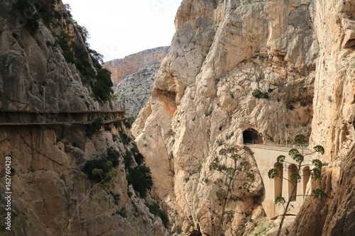 Bridge that supports the tracks of the train that cross the mountain by tunnels in the Caminito del Rey, Malaga, Spain