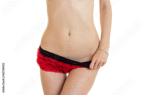 close-up portrait of a sexual woman's tummy and in red panties