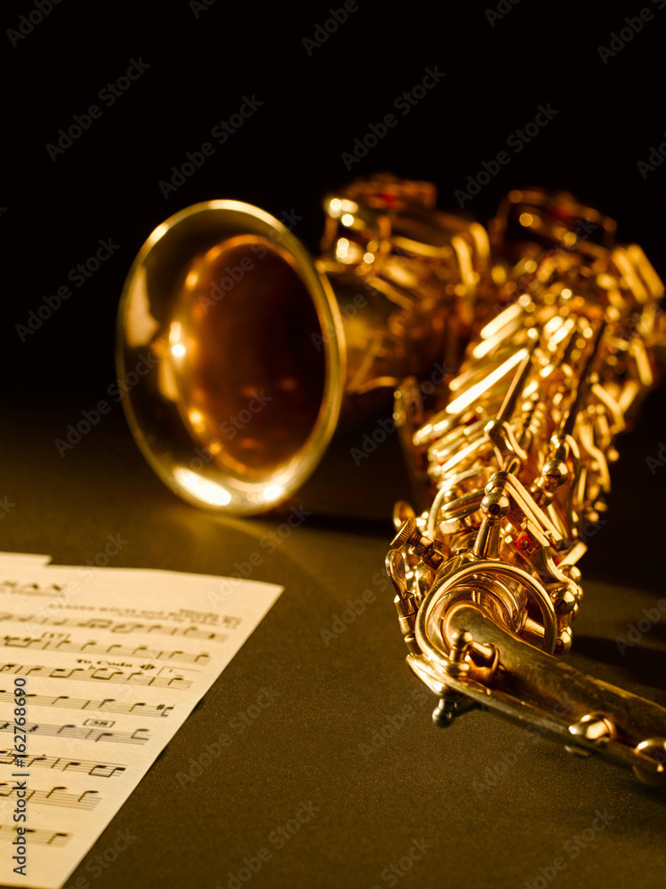 Fototapeta premium Golden saxophone on dark background.