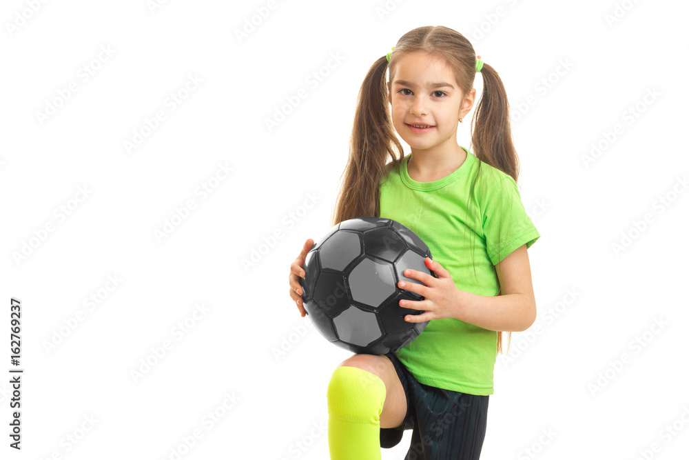 little cute girl with giant holds the ball and looks into a camera little cute girl with giant holds the ball and looks into a camera