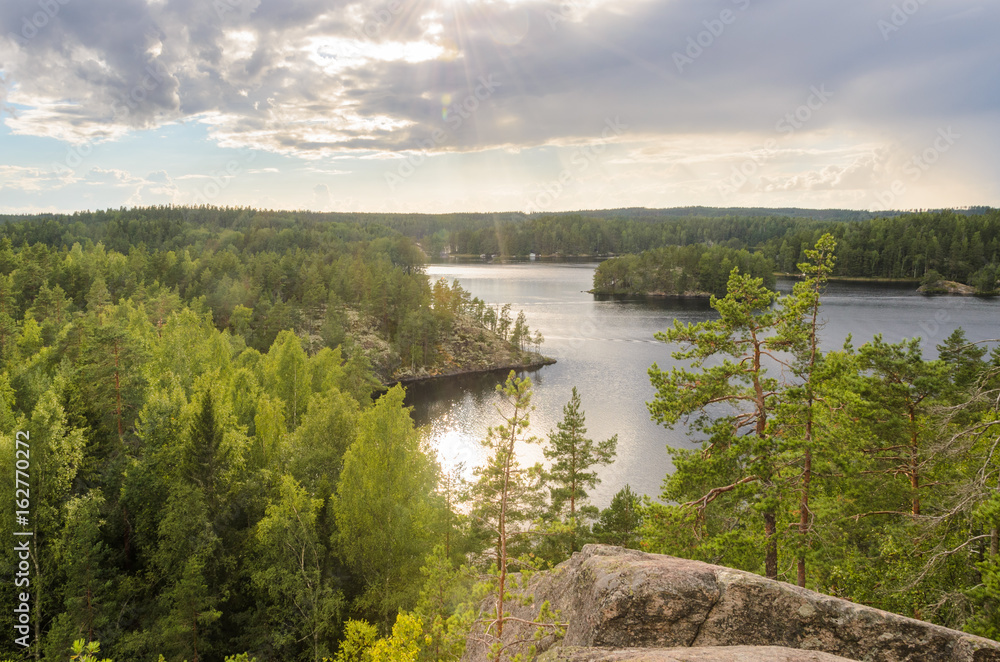 View from cliff over forest and lake. Finland.