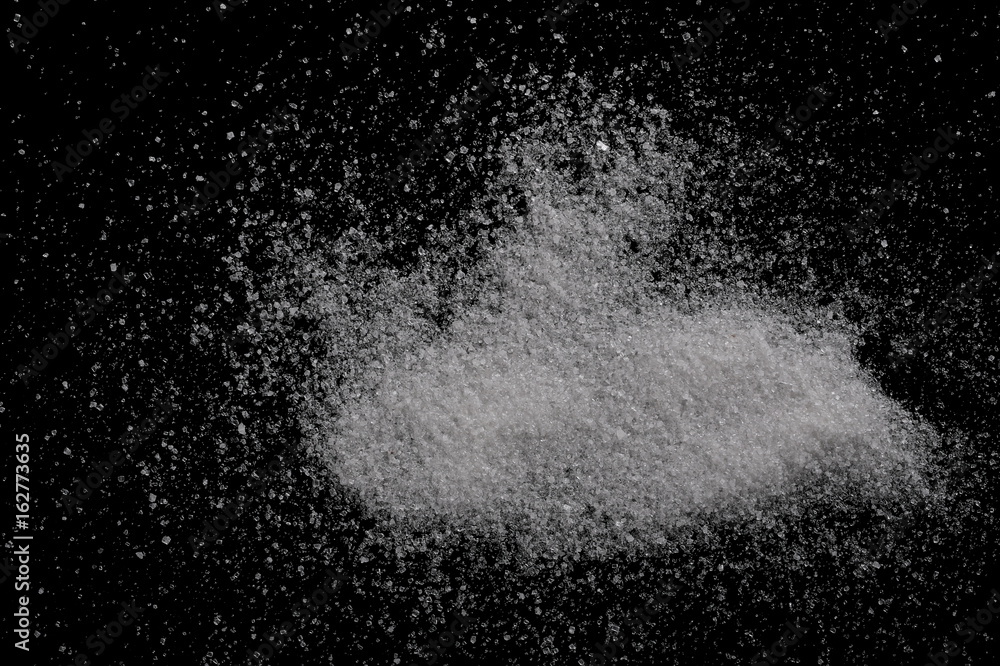 White sugar closeup isolated on black background and texture, top view White sugar closeup isolated on black background and texture, top view