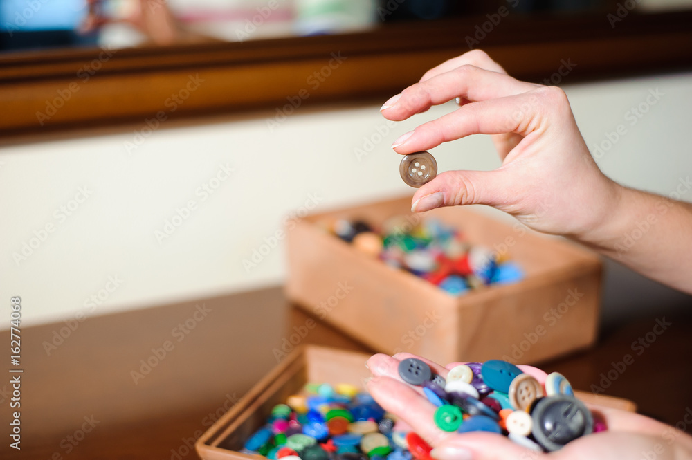 colorful sewing buttons in the hands colorful sewing buttons in the hands