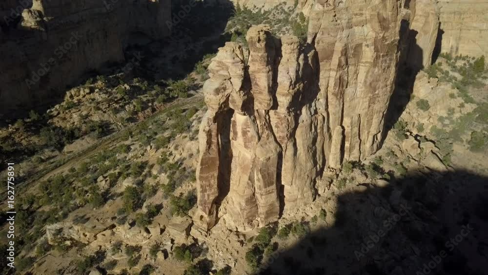 Aerial Eagle Arch San Rafael desert canyon valley Utah fly to. Overhead drone view. San Rafael Reef is a geologic feature in central Utah. Eroded into tall fins, domes, cliffs, and deep canyons.
