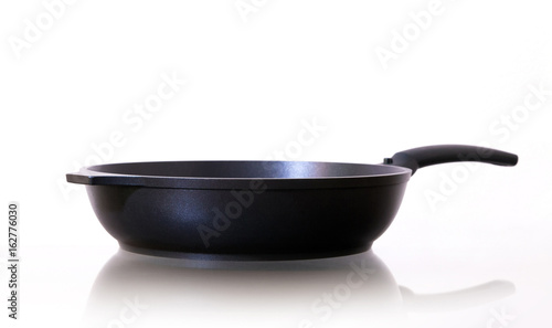 Frying pan. Closeup of a black frying pan on white background.