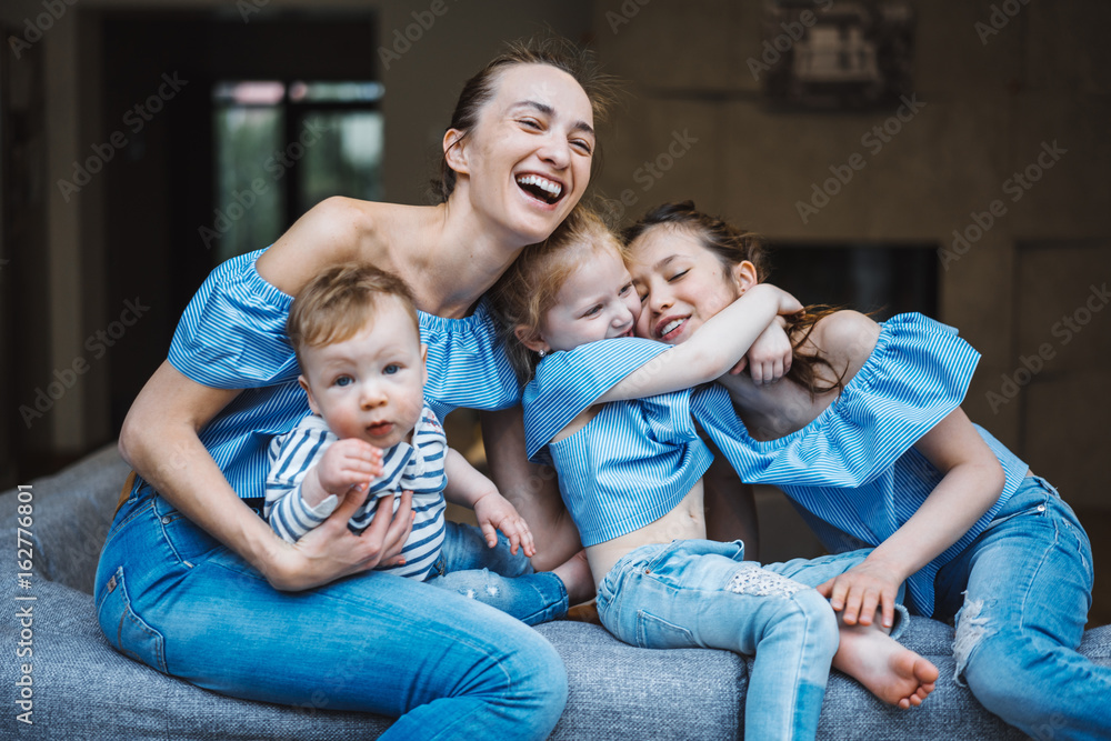 Mom, two daughters and a little son on the couch