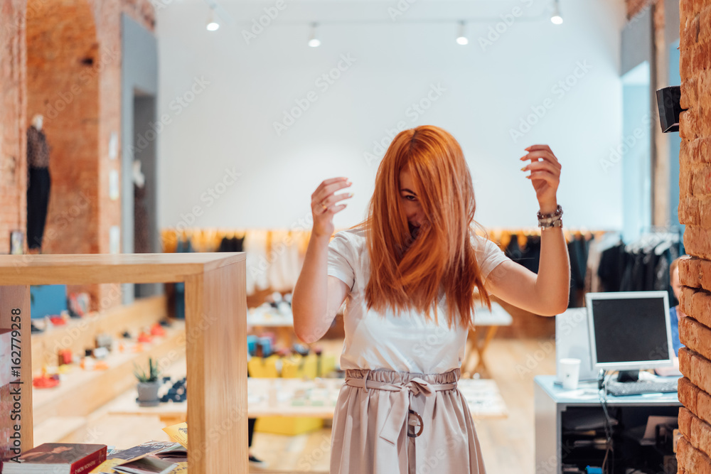 The woman is dancing in the store The woman is dancing in the store
