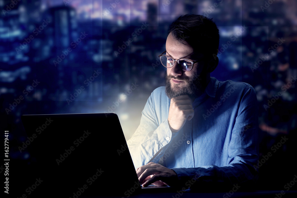 Businessman in the office at night Businessman in the office at night