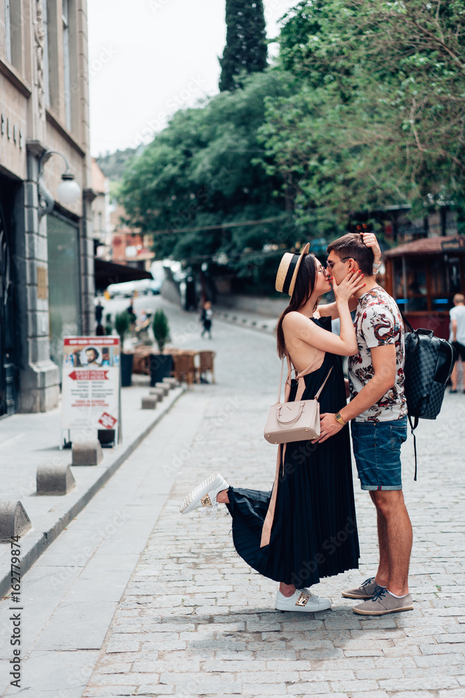 Naklejka premium Young couple in love, hugging on the street.