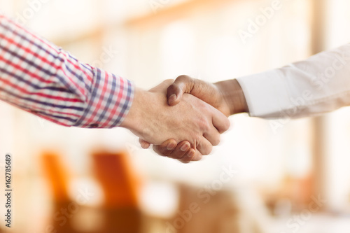 Handshake between african and a caucasian man