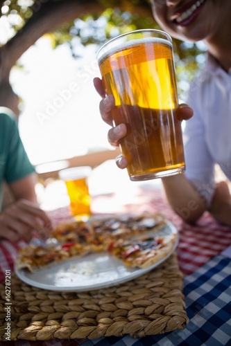 Cropped image of woman holding beer glass