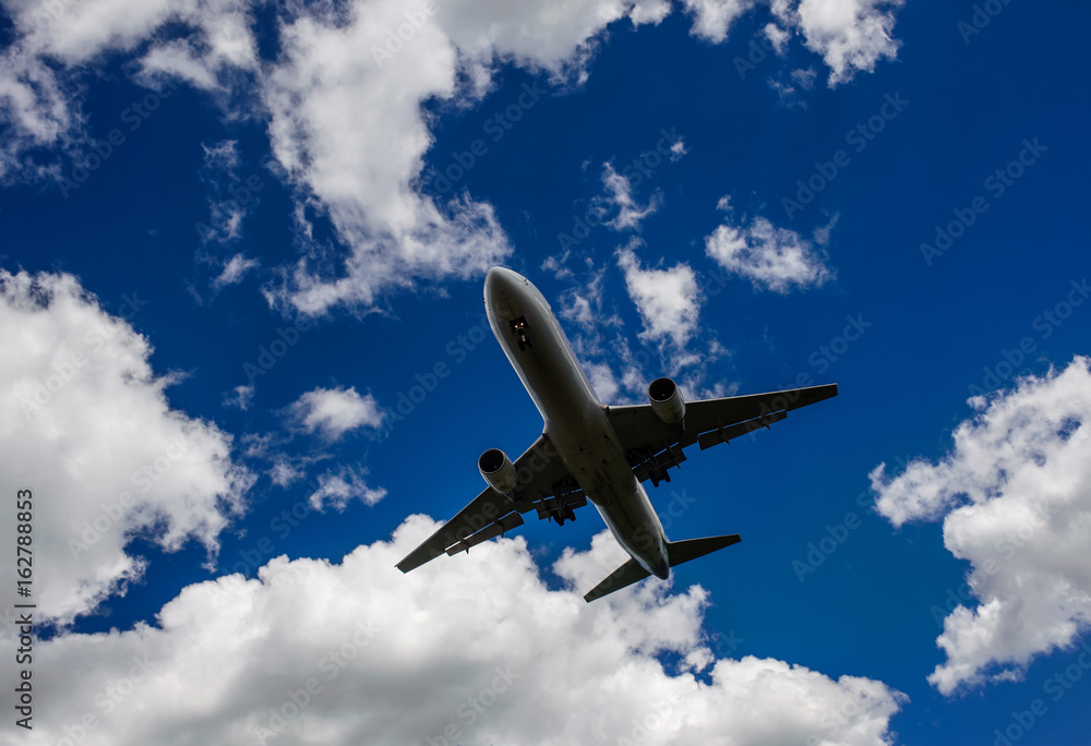 The plane on a background of blue sky and white clouds. The plane on a background of blue sky and white clouds.