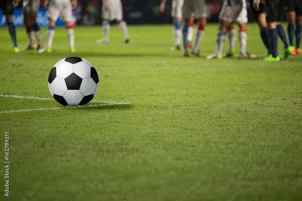 The soccer ball rests on the lawn while waiting for the footballer's ready. The soccer ball rests on the lawn while waiting for the footballer's ready.