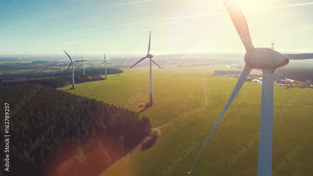 Windmill at windfarm on a sunny summer day