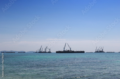 Cargo ship floating in the sea of sriracha city. © meepoohyaphoto