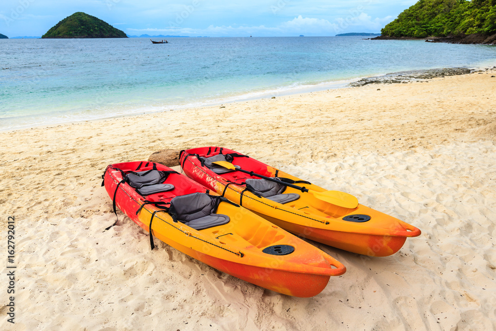 Two colorful empty canoe on the beach. Two colorful empty canoe on the beach.