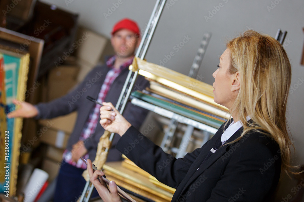 female manager talking to his worker in a warehouse