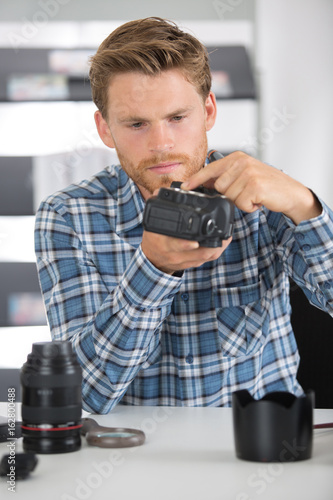 disassembled camera and photographer working photo