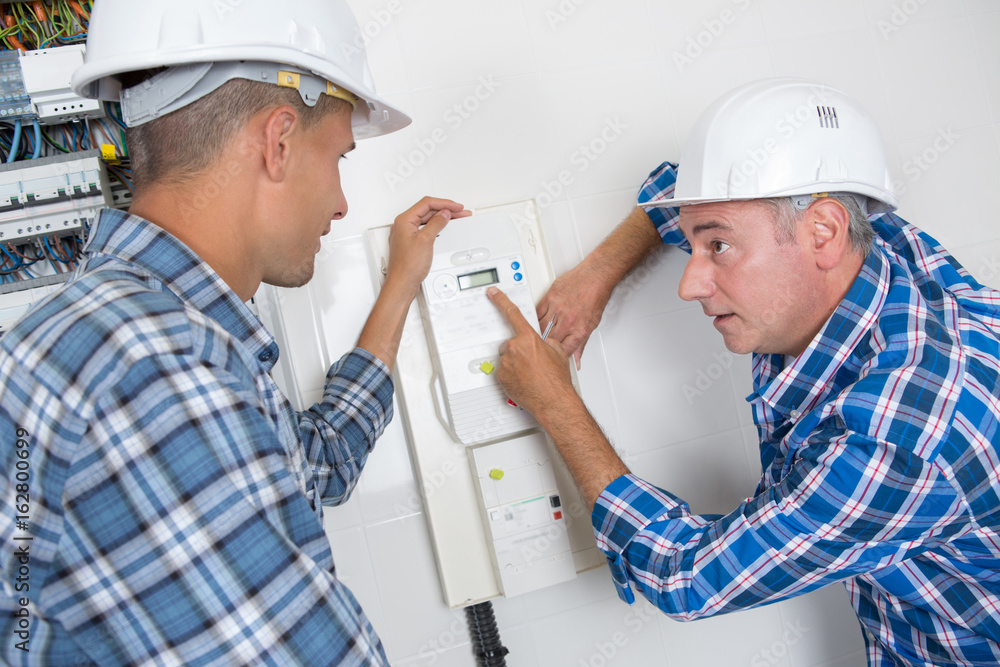 repairman engineer checking thermostat repairman engineer checking thermostat