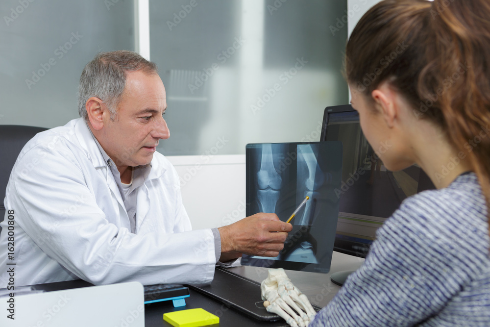 doctor showing xray results to patient doctor showing xray results to patient