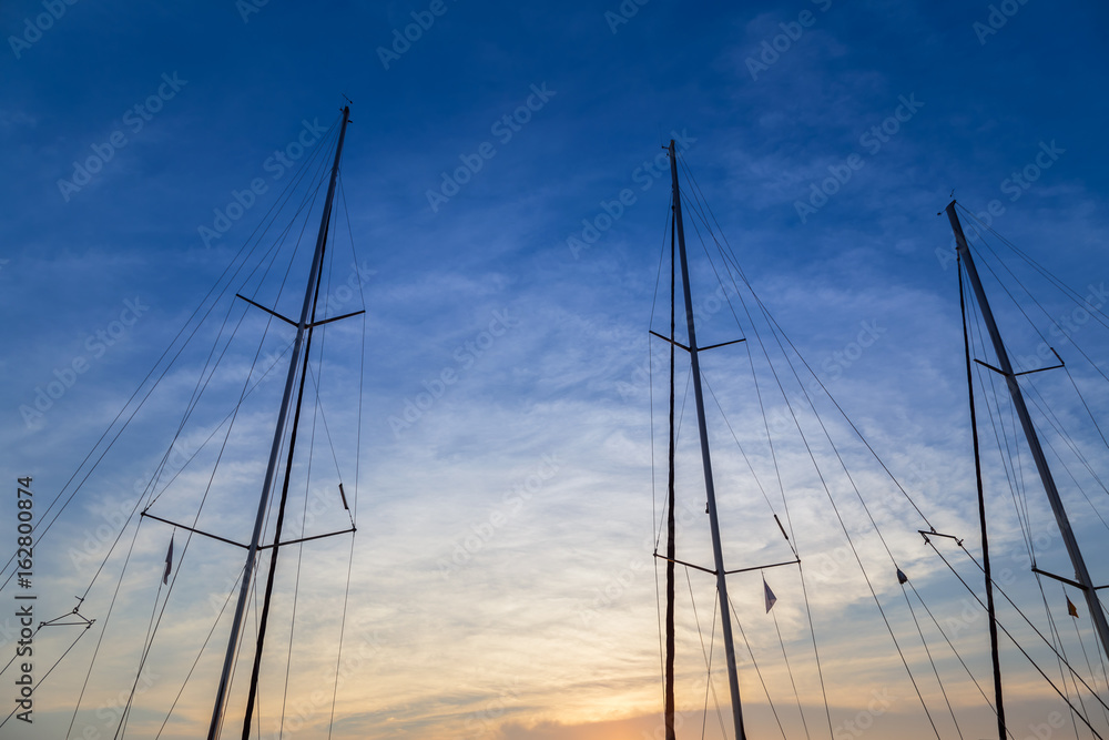 Masts of yachts at sunset