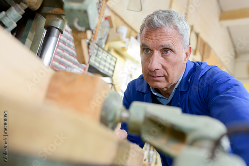 senior carpenter working at workshop