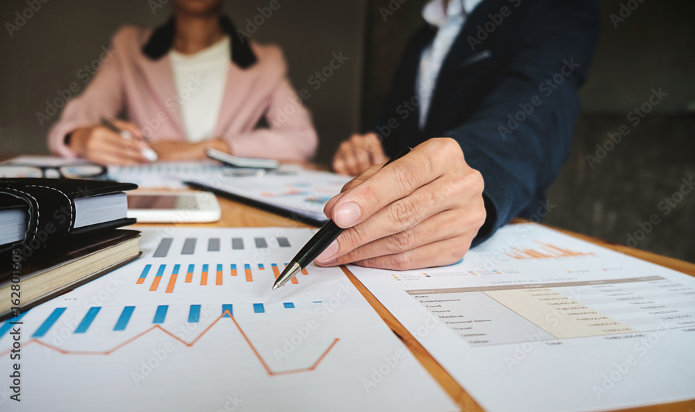 Business concept. Business people discussing the charts and graphs showing the results of their successful teamwork. Business concept. Business people discussing the charts and graphs showing the results of their successful teamwork.